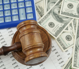 Money, gavel, and spreadsheets on the desk of a White Plains business bankruptcy attorney in New York.