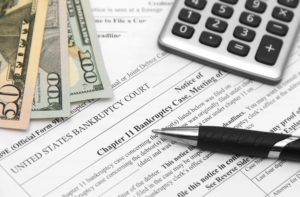 Paperwork and money on the desk of a White Plains chapter 13 bankruptcy attorney. 