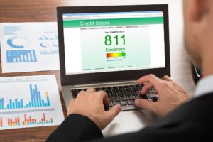 A bankruptcy attorney checking his credit score on a laptop in New Rochelle.