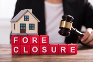 Foreclosure concept with toy house and Mount Vernon attorney with gavel in New York.