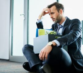 A sad businessman thinking about filing for bankruptcy in New Rochelle, New York.