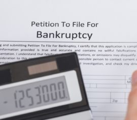 Businessman writing a petition to file for bankruptcy.